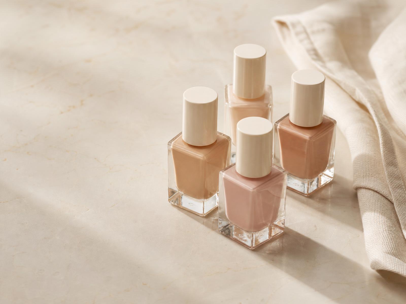 Nude nail polish still life on cream marble